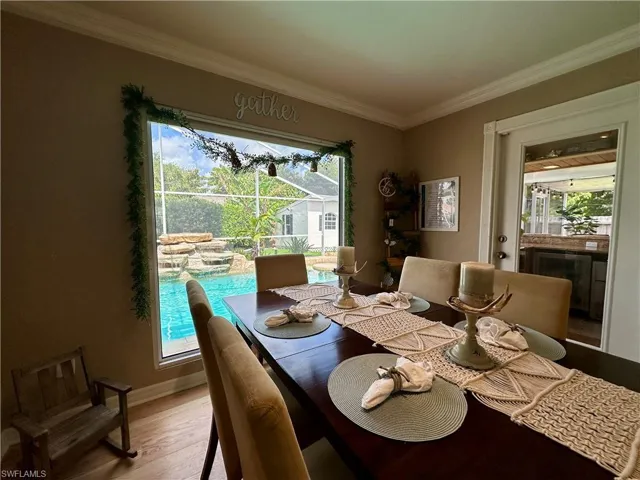 Dining room featuring crown molding and light hardwood / wood-style flooring