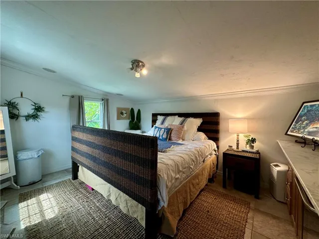 CABANA Bedroom with tile patterned flooring and ornamental molding