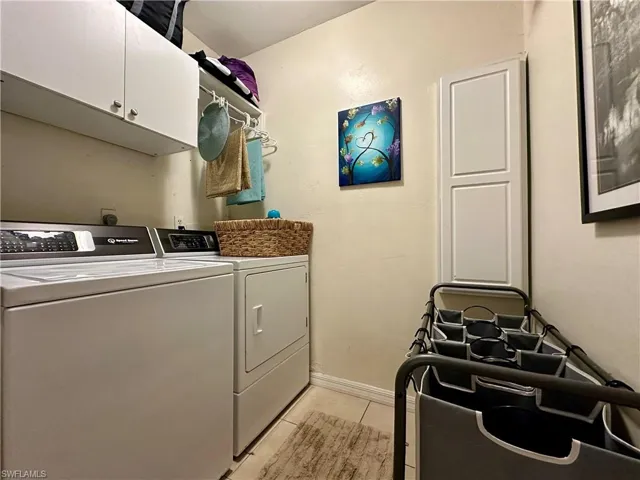 Clothes washing area patterned flooring, washer and clothes dryer, and cabinets