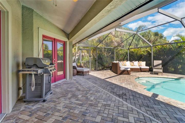 French doors off the living area and master bedroom lead you to large enclosed paved lanai with a beautiful pool