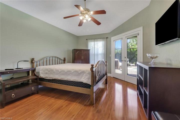 Bright and spacious master bedroom with french doors that lead you to outside.