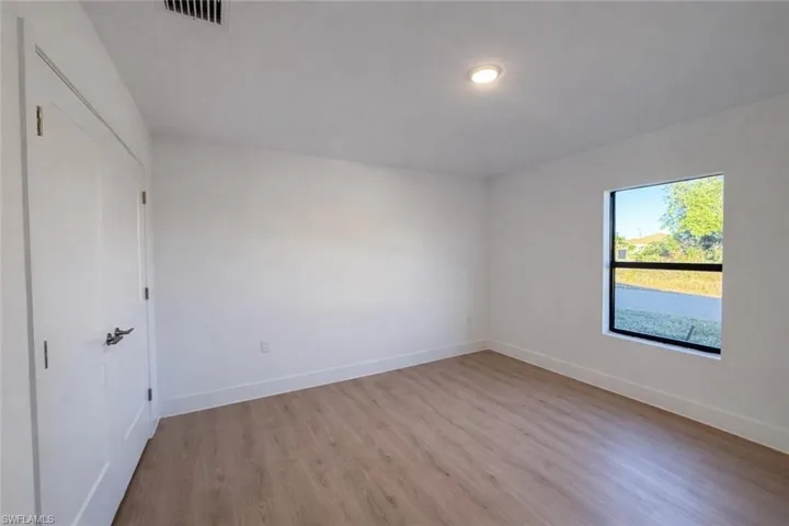 Unfurnished bedroom with light wood-style floors and a closet