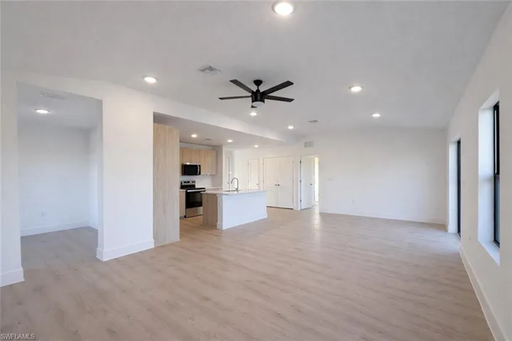 Unfurnished living room featuring light wood-style flooring, recessed lighting, and ceiling fan