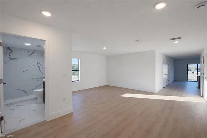 Spare room featuring light wood-style flooring and recessed lighting