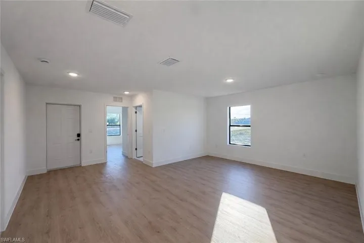 Empty room with plenty of natural light, light wood-type flooring, and recessed lighting