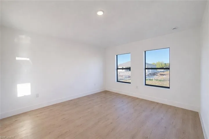 Empty room featuring light wood-style flooring and baseboards