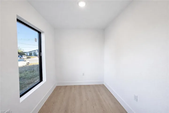 Empty room featuring baseboards and light wood finished floors