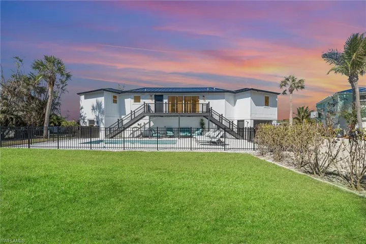 Contemporary two-story residence with a dark metal roof and white exterior