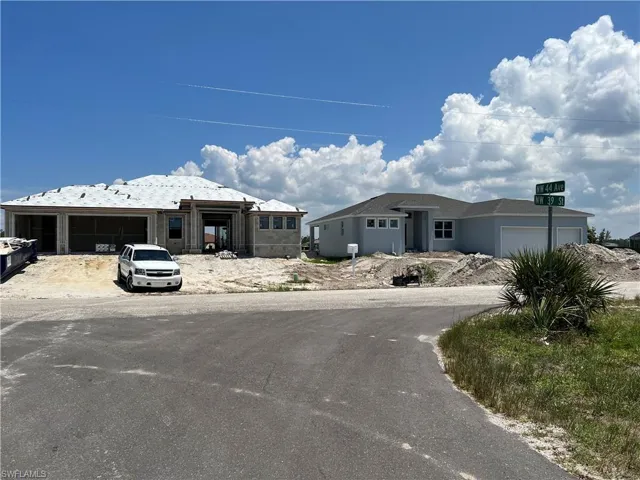 New home construction right across street - 3 car garage homes along large lake