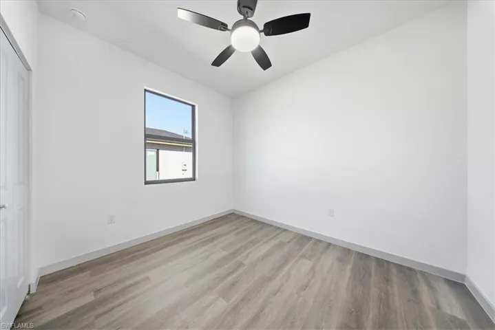 Unfurnished room with light wood-style floors and a ceiling fan