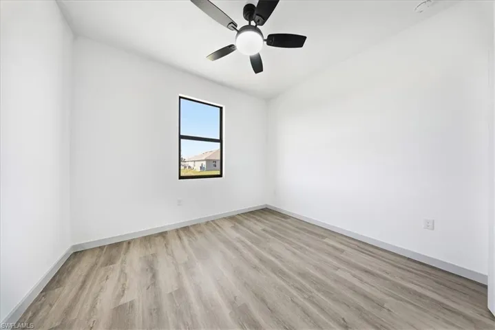 Unfurnished room with light wood-style floors and a ceiling fan
