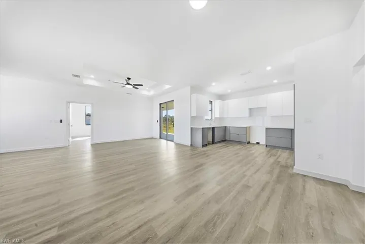 Unfurnished living room with light wood finished floors, recessed lighting, and ceiling fan