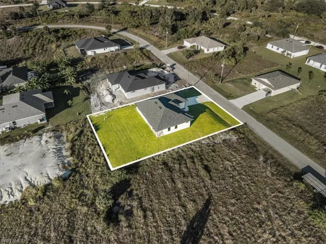 Aerial overview of property's location with property boundaries highlighted and nearby suburban area