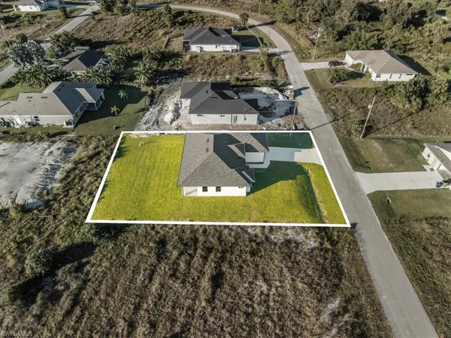 Aerial view of residential area featuring property boundaries highlighted