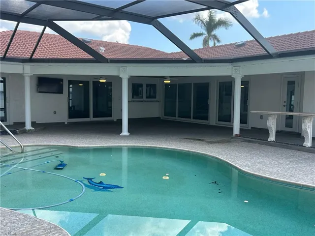 View of pool with ceiling fan, a lanai, and a patio area