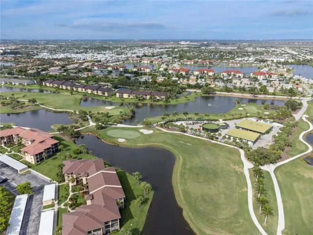 Birds eye view of property with a water view