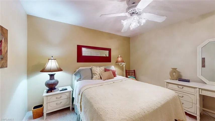 Carpeted bedroom featuring ceiling fan
