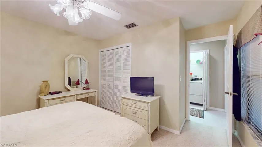Bedroom with washer / dryer, a closet, and ceiling fan