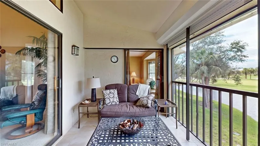 Sunroom / solarium featuring lofted ceiling