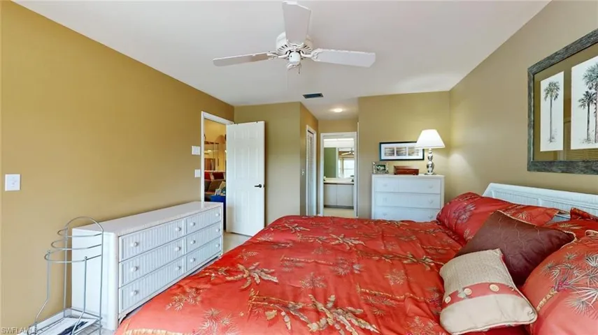 Bedroom featuring ceiling fan and connected bathroom