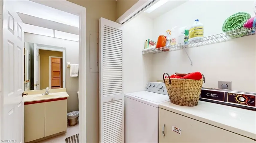Laundry room with sink, hookup for an electric dryer, and washer and clothes dryer