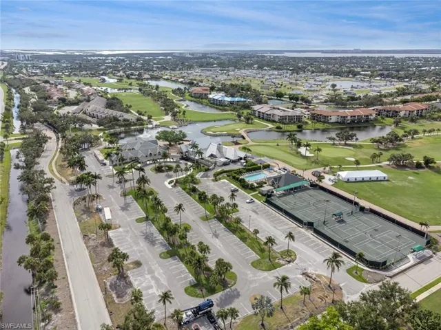 Birds eye view of property with a water view