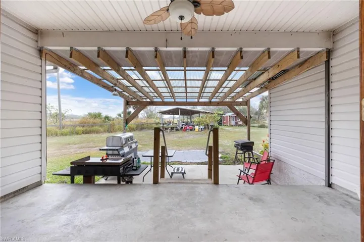 View of patio with a ceiling fan and area for grilling
