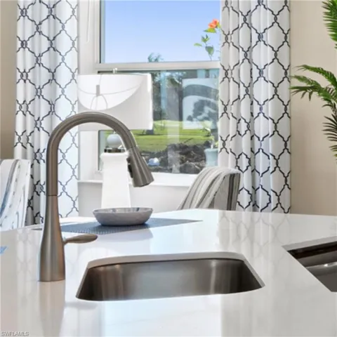 Interior details with light stone counters and a sink