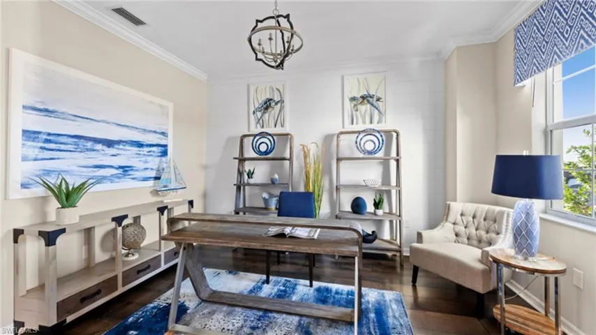 Office area featuring visible vents, a notable chandelier, wood finished floors, and crown molding