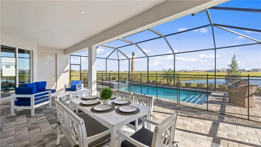View of patio with glass enclosure, an outdoor living space, and a pool with connected hot tub