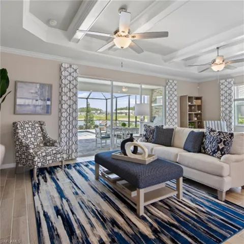 Living area featuring wood finished floors, a healthy amount of sunlight, and a ceiling fan