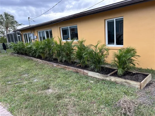 View of side of home with a yard