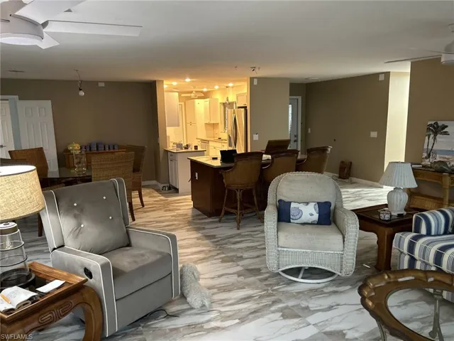 Prior to Milton.  Living room looking towards dining area on the left and island into the kitchen.