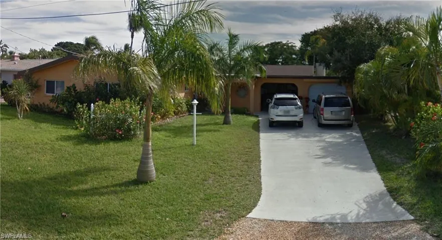 Single story home featuring a front lawn and a garage