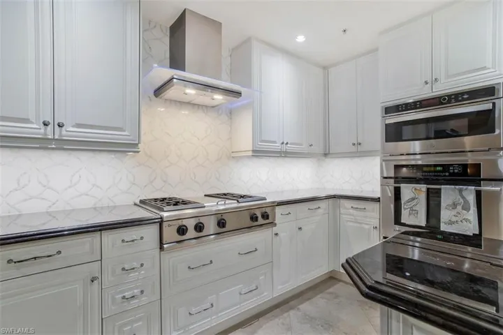 Imported Backsplash with white marble and mother of pearl in-lay ribbon design.