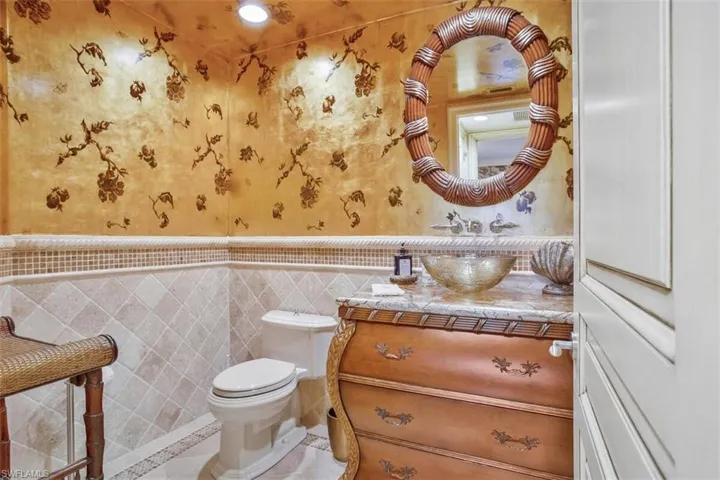 Exquisite gold foil wall paper in the guest half-bath