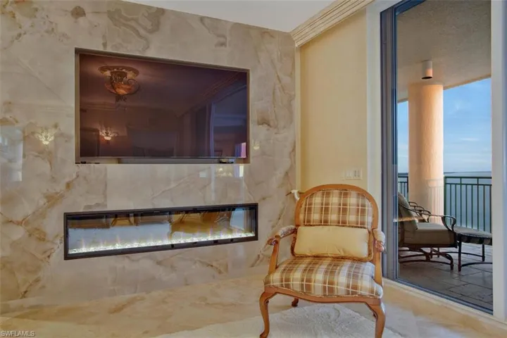 Stunning accent wall surrounding the TV and the stunning fireplace accent that offers heat and different color light palette.