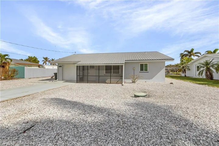 Back of property featuring a sunroom