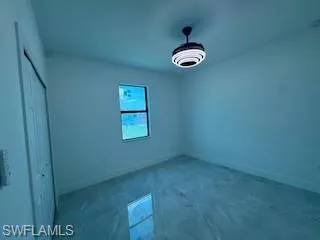Unfurnished bedroom featuring a closet and baseboards