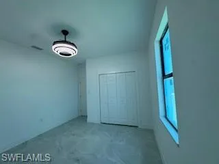 Unfurnished bedroom with a closet and baseboards