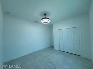Unfurnished bedroom featuring a closet and baseboards