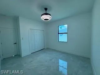 Unfurnished bedroom featuring baseboards and a closet