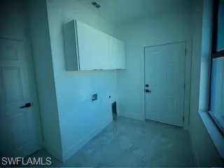 Laundry area featuring electric dryer hookup, cabinet space, and washer hookup