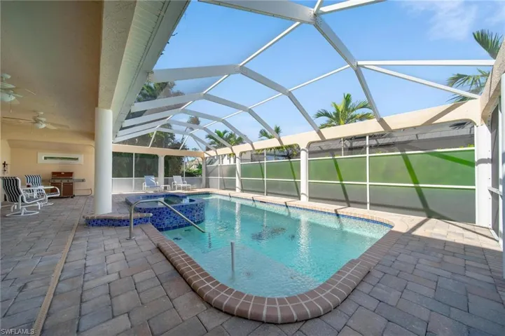 View of swimming pool featuring a lanai, an in ground hot tub, ceiling fan, and a patio