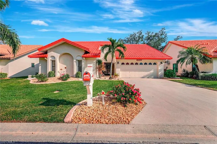 Mediterranean / spanish home featuring a front yard and a garage