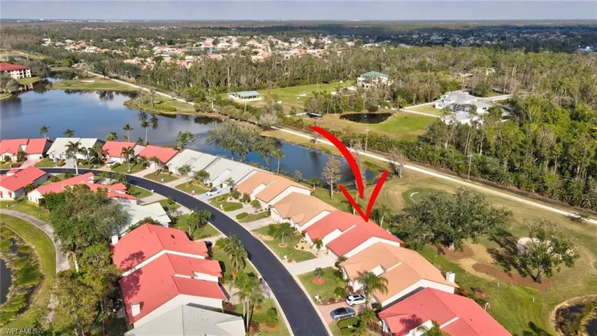 Birds eye view of property with a water view