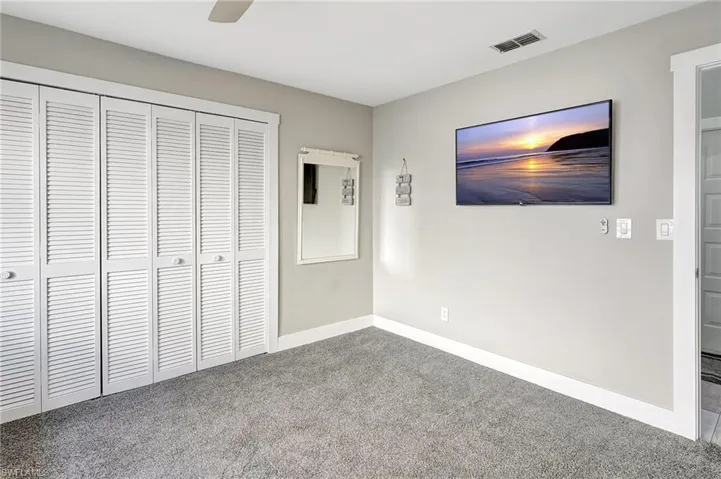 Unfurnished bedroom with carpet, a closet, and ceiling fan
