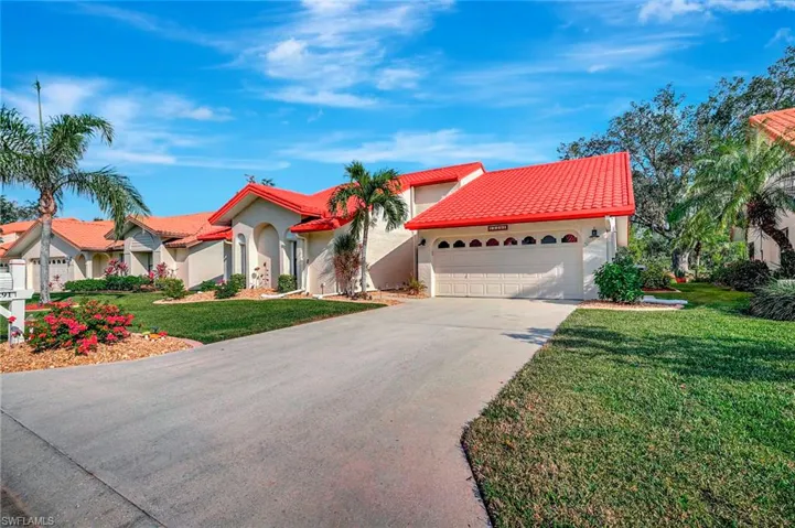 Mediterranean / spanish house with a garage and a front lawn