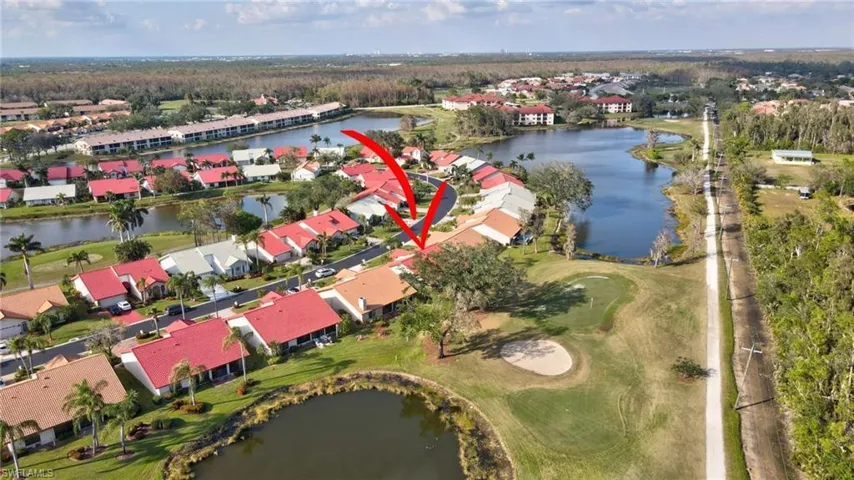 Birds eye view of property with a water view