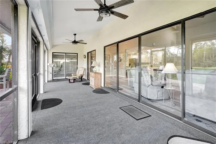 Sunroom / solarium with ceiling fan, a wealth of natural light, and vaulted ceiling